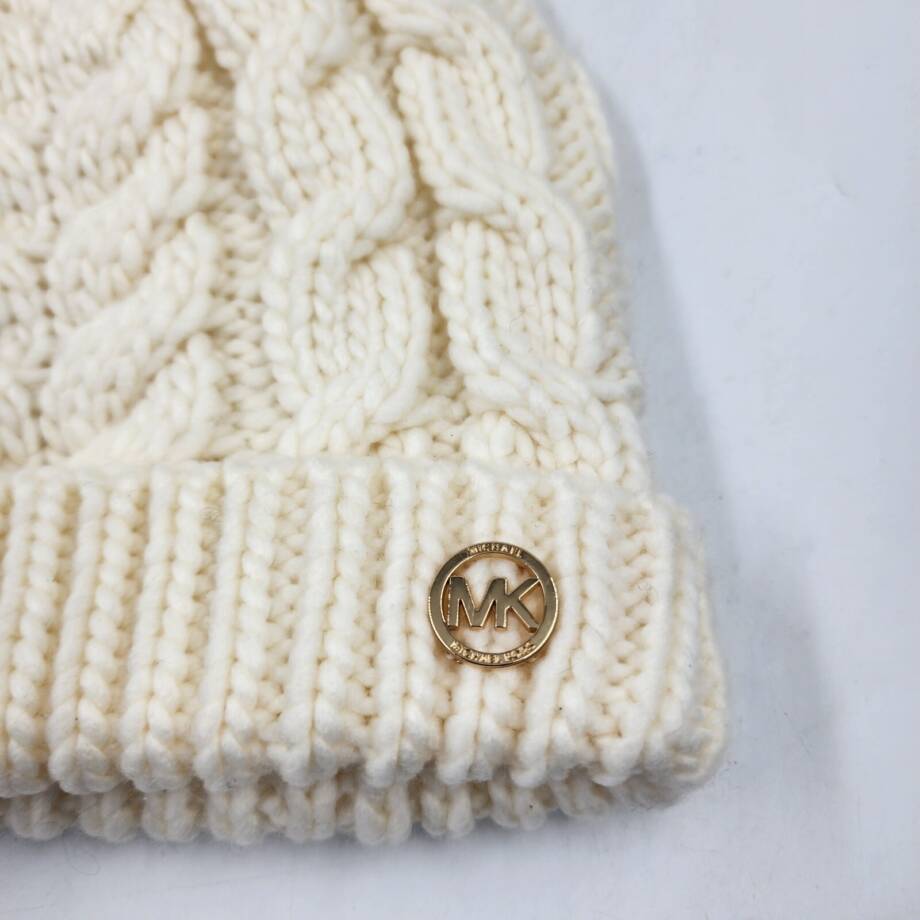 Michael Michael Kors Moving Cables Knit Hat Women's Cream Ribbed Logo Charm